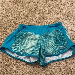 Teal and white patterned Nike running shorts
